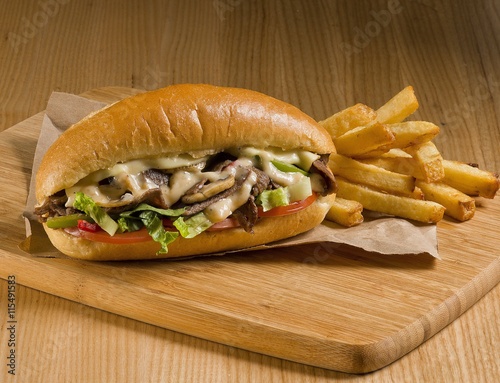 cheesesteak sandwich on cutting board