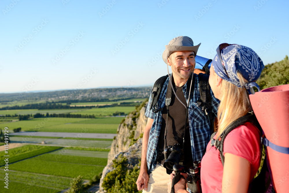 Fototapeta premium young couple hiking together with backpack on an adventure trek