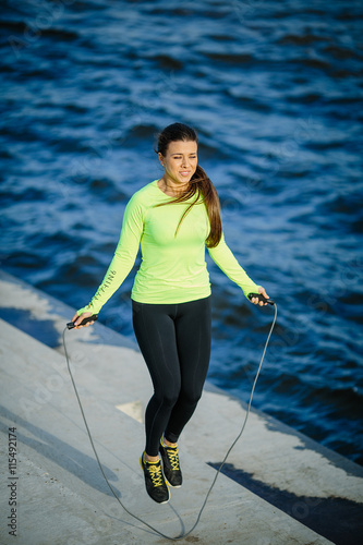 Young woman with jumping rope photo