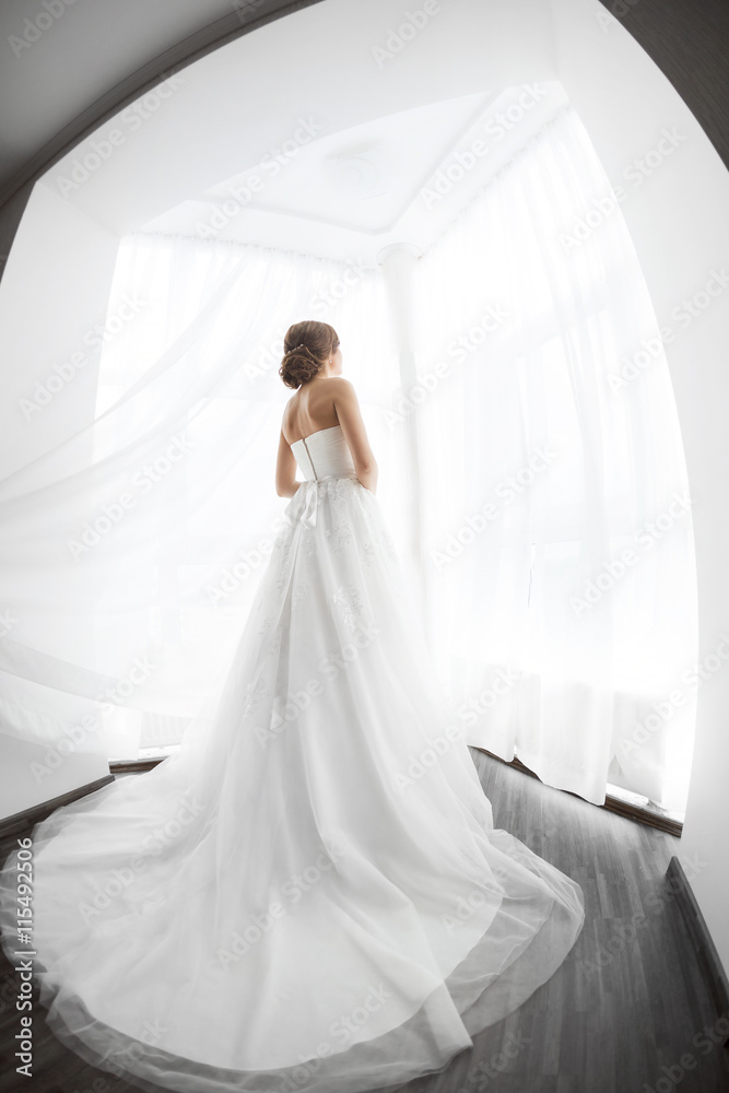 Brides beauty. Young woman in wedding dress indoors Brides beauty. Young woman in wedding dress indoors