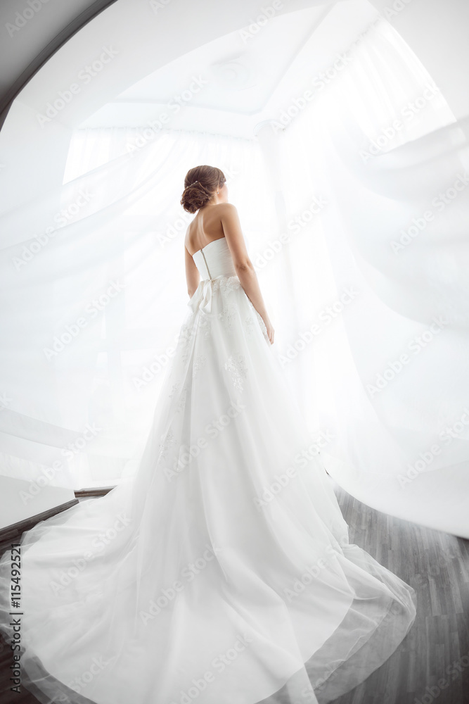 Brides beauty. Young woman in wedding dress indoors Brides beauty. Young woman in wedding dress indoors
