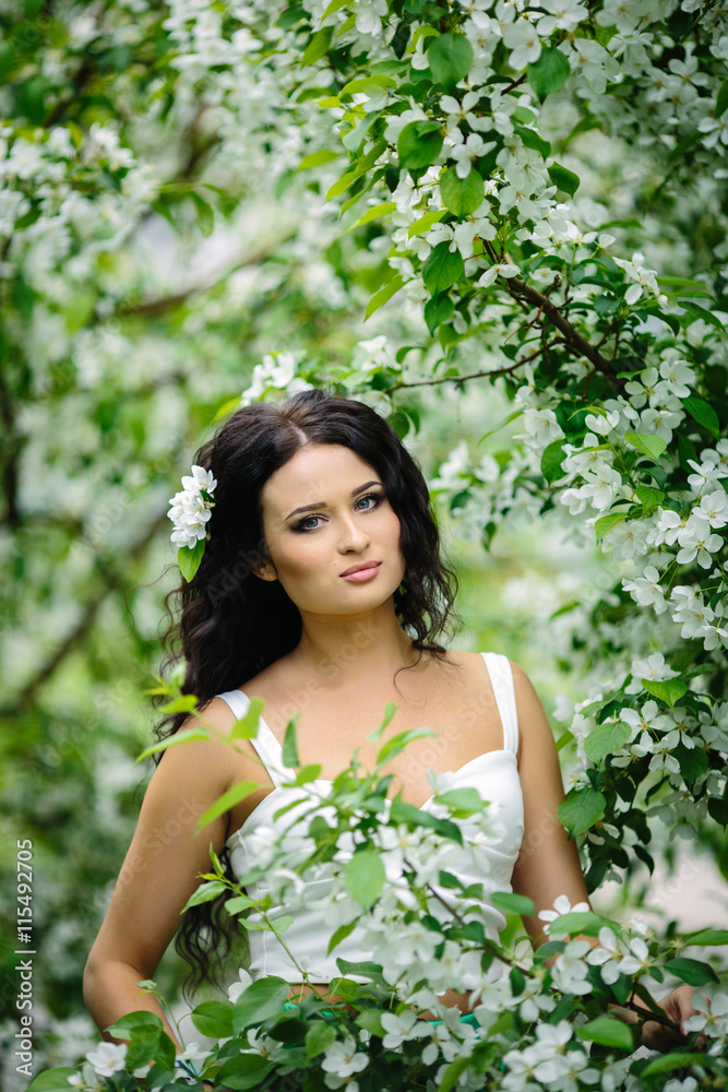 Young brunette woman portrait in blooming apple tree park Young brunette woman portrait in blooming apple tree park