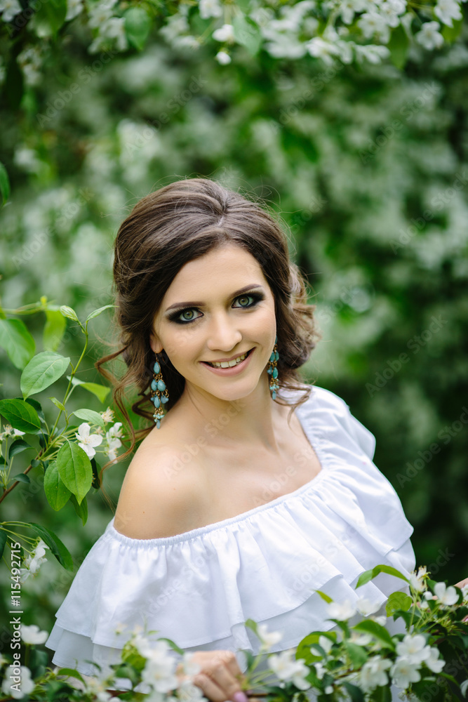 Young brunette woman portrait in blooming apple tree park Young brunette woman portrait in blooming apple tree park