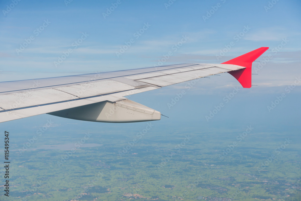 Wing of an airplane flying above the clouds Wing of an airplane flying above the clouds