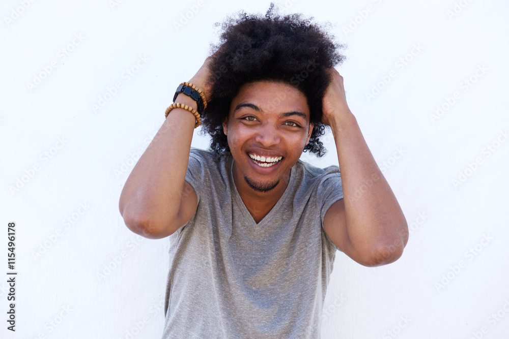 Young man laughing with hand in hair Young man laughing with hand in hair