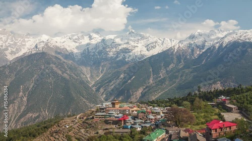 Time Lapse. Picturesque view of Kalpa village (2960 m) and Kinnaur Kailash sacred peak (6050 m) at sunrise. Spiti valley, Himachal Pradesh, India. photo