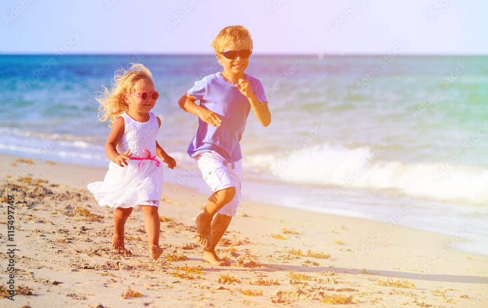 little boy and girl running at beach little boy and girl running at beach