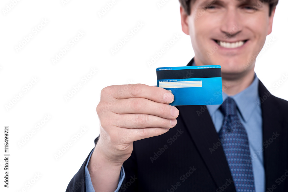 Businessman showing backside of a credit card.