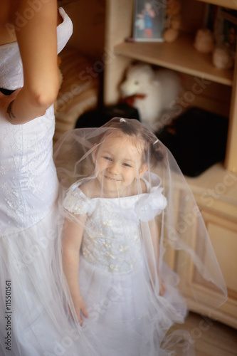 small girl under the bride dress