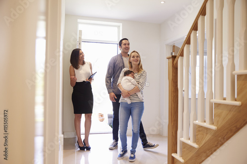 Obraz na plátne Realtor Showing Young Family Around Property For Sale