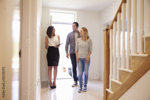 Realtor Showing Young Couple Around Property For Sale photo