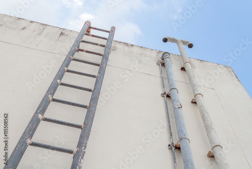 Staircase old vertical industrial metal rusted. to Water tank no safety rails