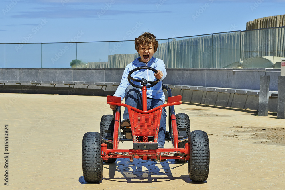 Young boy driving a Quadricycle Young boy driving a Quadricycle