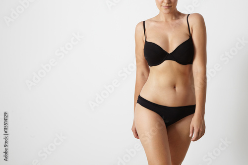 normal woman's body wears swimsuit on a white background