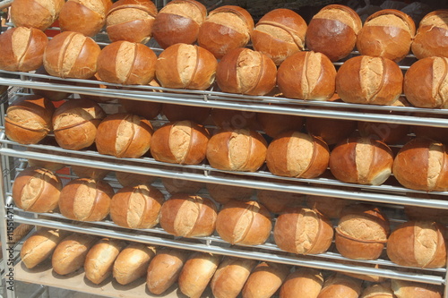 Fresh round loaves of bread in bakery shop. 