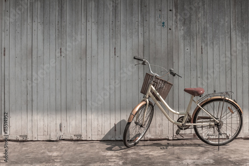 vintage bicycle on vintage wooden house wall