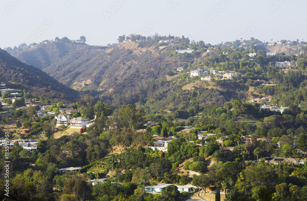 City on a background of mountain range. House, hill and blue sky in USA, Santa Monica. 
