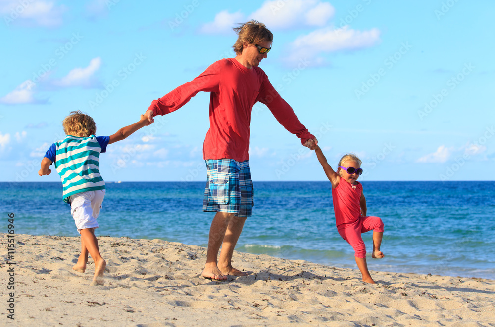 father with son and daughter play at beach father with son and daughter play at beach