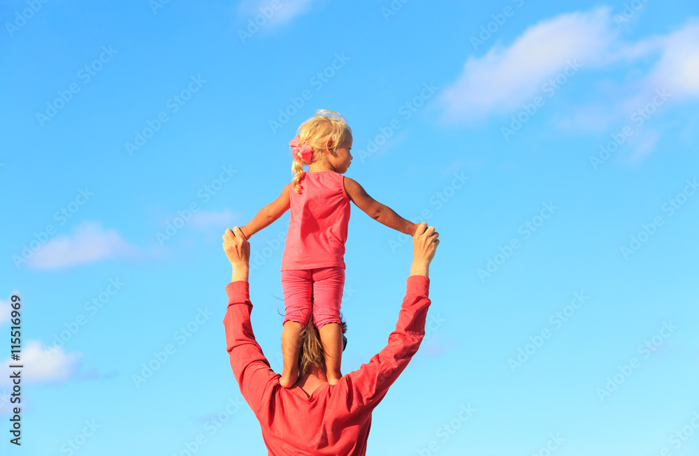 father and little daughter play at sky father and little daughter play at sky