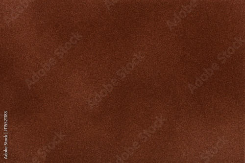 Dark brown suede fabric closeup. Velvet texture.