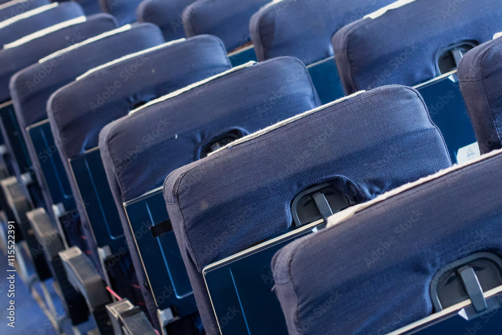 Empty old airplane seats in the cabin, selective focus Stock Photo