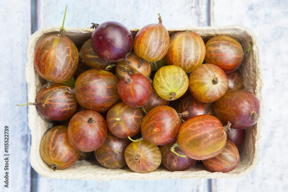 Cardboard box of red gooseberries