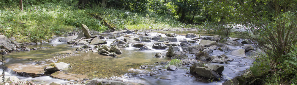 The river - flowing water between the rocks. The river - flowing water between the rocks.