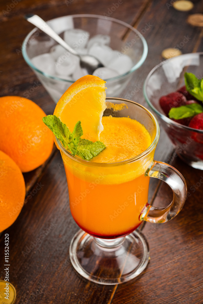 Fototapeta premium beautiful sweet cocktail with orange strawberry and ice