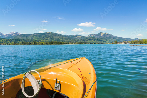 Yellow electric boat on the lake photo