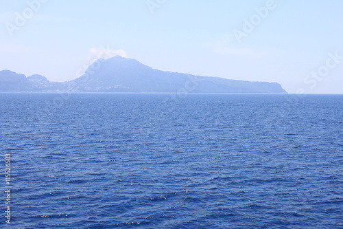 View of the island of Capri from the Tyrrhenian Sea in clear weather. Campania, Italy.