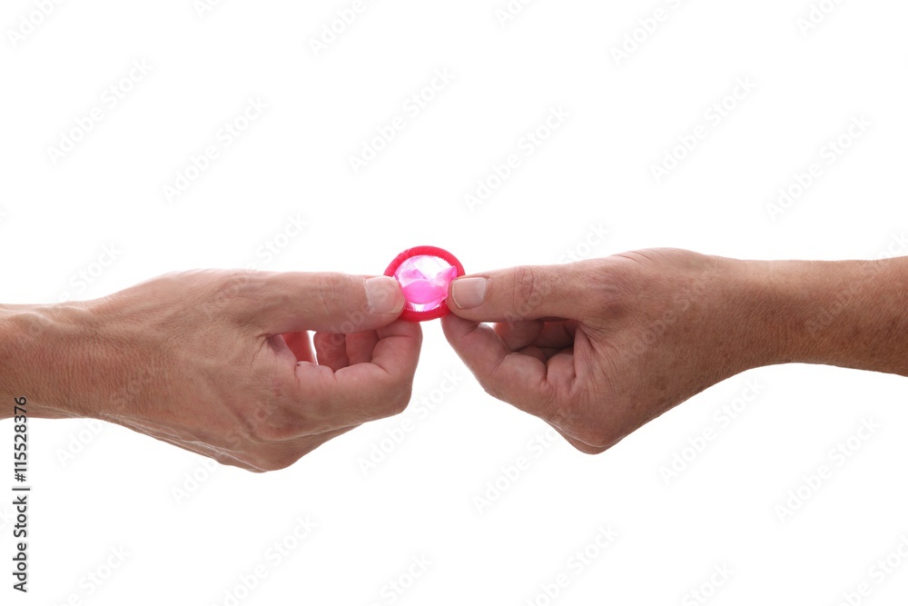 male gay couple hands giving condom