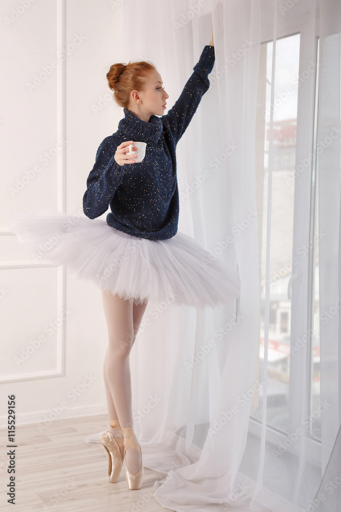 Ballerina drinking black tea by the window Ballerina drinking black tea by the window