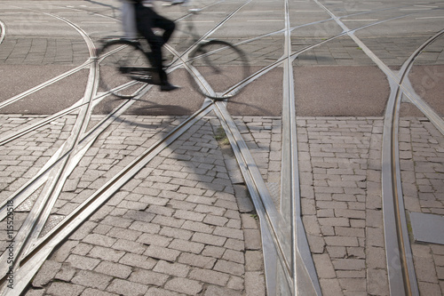 Obraz na płótnie Bike and Cyclist on Tram Tracks, Rotterdam w salonie
