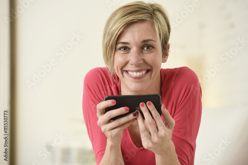 young beautiful Caucasian woman happy using internet app on mobile phone smiling happy
