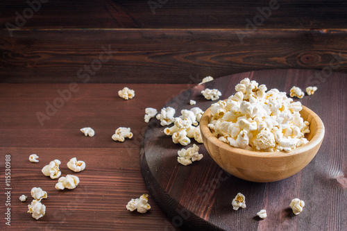 Salt popcorn on the wooden table