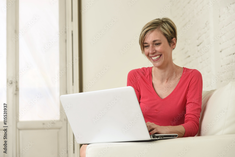young beautiful woman smiling happy working at home with laptop computer on sofa couch young beautiful woman smiling happy working at home with laptop computer on sofa couch