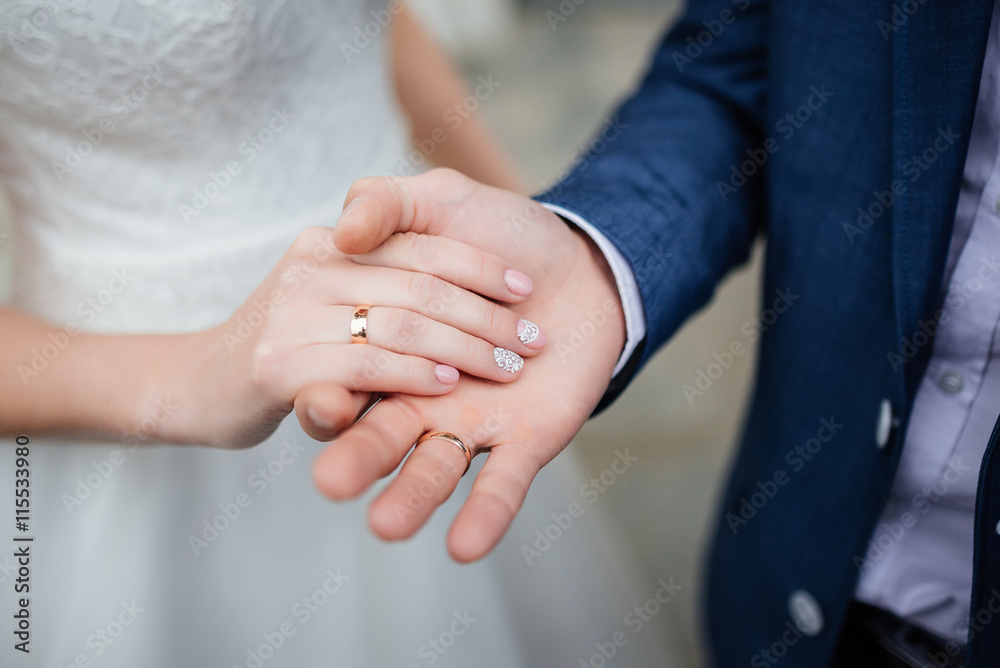 Newly wed couple's hands with wedding rings Newly wed couple's hands with wedding rings