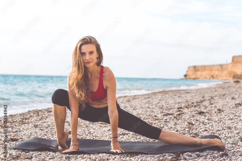 Sportive woman doing yoga poses on the beach Sportive woman doing yoga poses on the beach