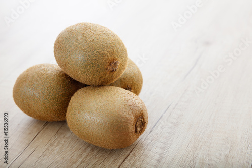Kiwis on a wooden surface