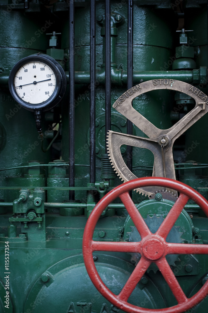 Vintage Steam Engine Dial. An old working steam engine with interesting dials and pipes alluding to an industrial age of another era.