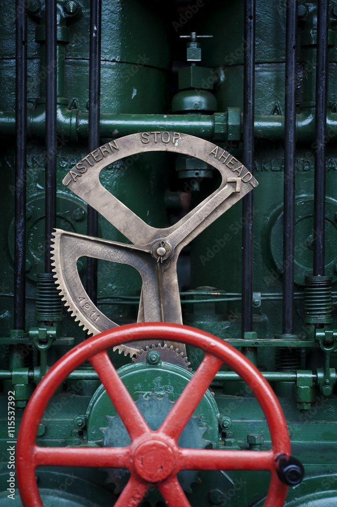 Steam Engine Wheels. An old working steam engine with interesting wheels and pipes alluding to an industrial age of another era.