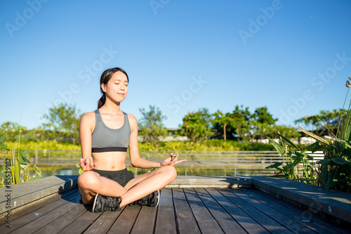 Woman doing yoga at outdoor © leungchopan