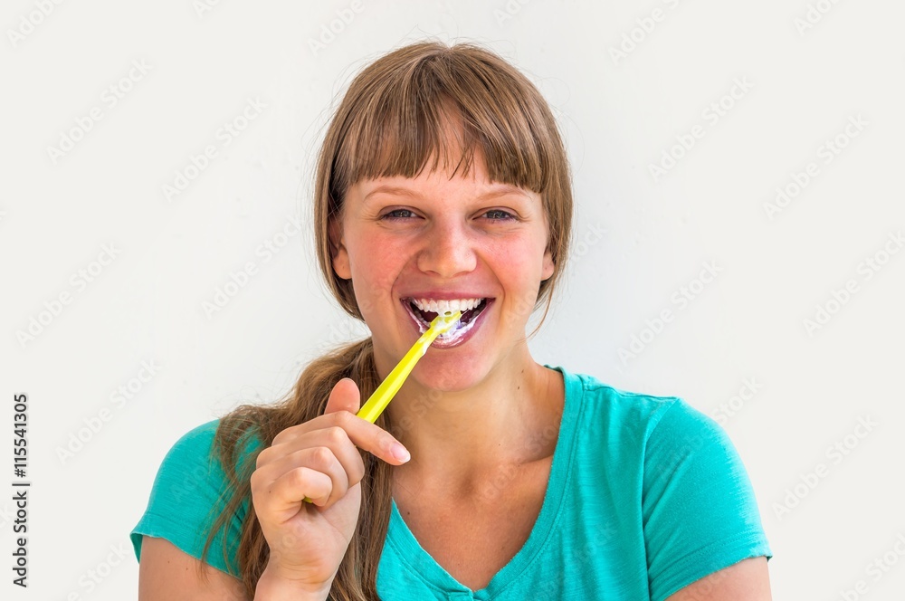 Young lady brushing teeth in the morning Young lady brushing teeth in the morning