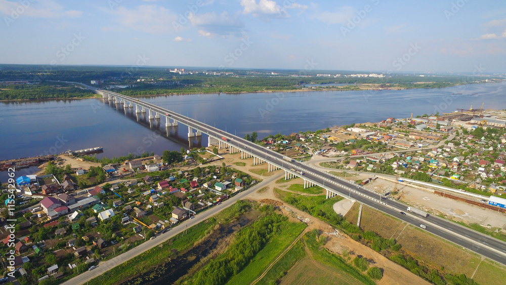 bridge over  river in provincial green town aerial view