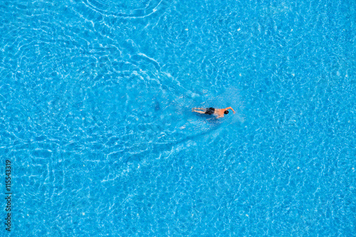 Man swim in the pool at the hotel