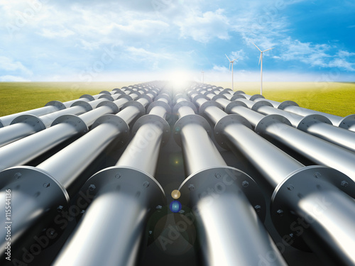 metal pipeline with green field and blue sky background