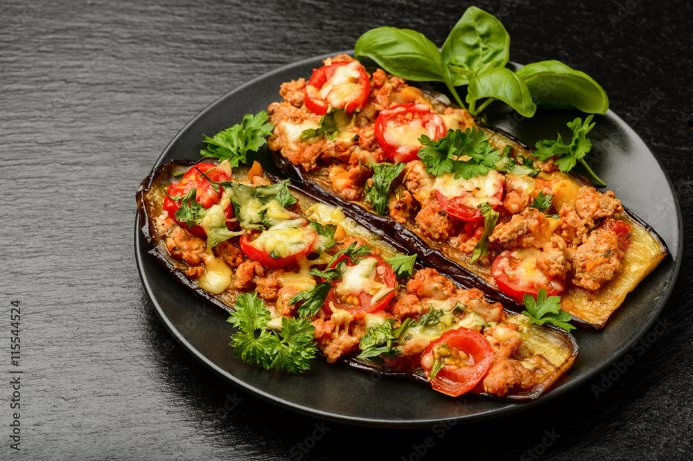 Delicious appetizer -grilled eggplants baked with minced meat, tomatoes and cheese.