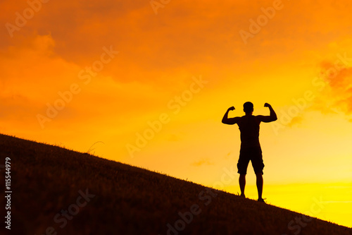 Fit male flexing outdoors. Active and healthy lifestyle concept.