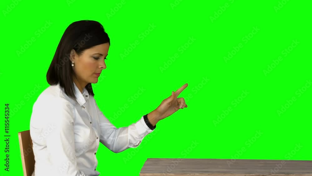 Irritated businesswoman sitting on chair on green screen Irritated businesswoman sitting on chair on green screen