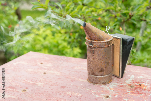 European version of an old rusty bee smoker. Beekeeper's tool..